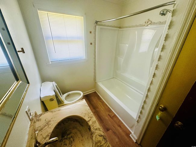 Bathroom featuring wood finished floors, toilet, and shower / bathtub combination | Image 19