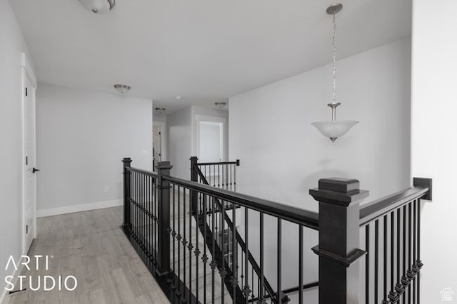 Hall featuring wood finished floors, an upstairs landing, and baseboards | Image 23