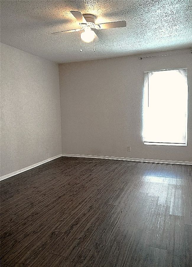 Bedroom with arched window and ceiling fan | Image 10