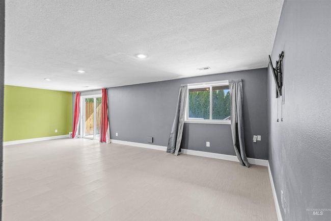 Empty room with a textured ceiling, recessed lighting, and light floors | Image 31
