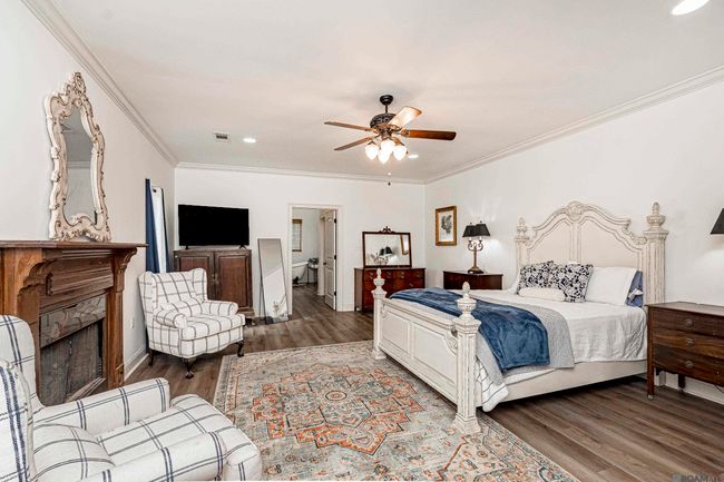 Primary bedroom has a gas fireplace and space that is large enough for sitting area and or office space | Image 21