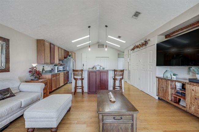 Back to the Living Room, the light and beautiful bamboo floor spans the length of the open concept area, with an open invitation to family and guests. | Image 28