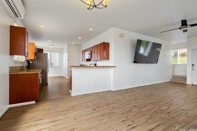 Back in the living room, use the hallway on the right to go upstairs to the bedrooms. There is a half bathroom on the left. | Image 7