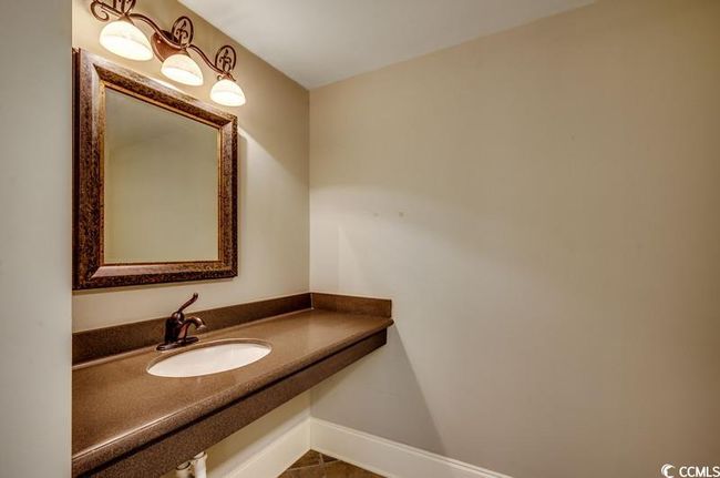 Bathroom featuring a sink and baseboards | Image 17