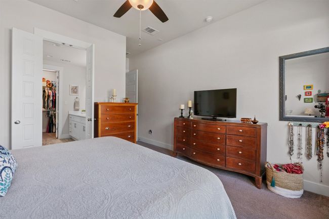 Bedroom featuring carpet floors, baseboards, a ceiling fan, and a walk in closet | Image 16