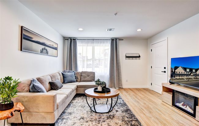 Living area with light wood finished floors, visible vents, recessed lighting, and baseboards | Image 5