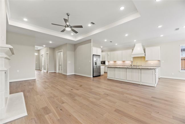 This open floor plan is ideal for both comfortable daily living and easy entertaining, with seamless flow from the spacious family room to the chef-inspired kitchen. The expansive layout allows for effortless connection between cooking, dining, and relaxing, all in one beautifully cohesive space. | Image 11