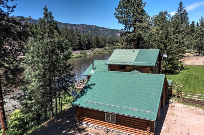 Aerial view of property and surrounding area featuring a heavily wooded area and a nearby body of water | Image 70