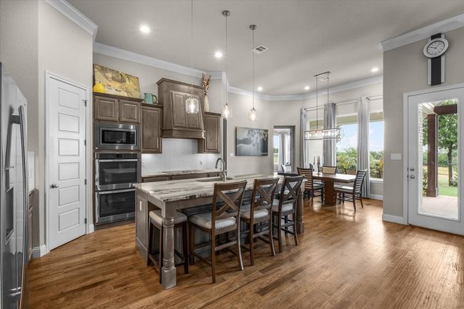 Kitchen featuring large center island with storage cabinets | Image 6