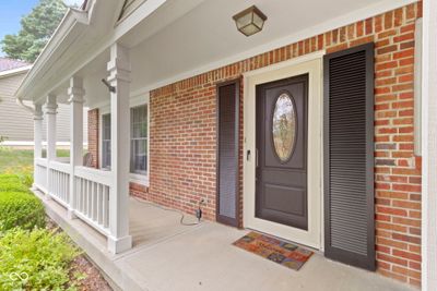 Two areas for outdoor living space in this home and this is one of them. Spacious covered front porch with plenty of space for furniture. Upgraded Fiberglass entry door is beautiful and welcoming. | Image 3