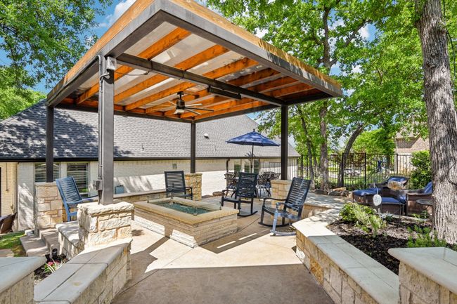Covered outdoor living space with fire pit | Image 36