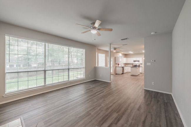 Wall of windows in the family room allowing for natural light. | Image 19