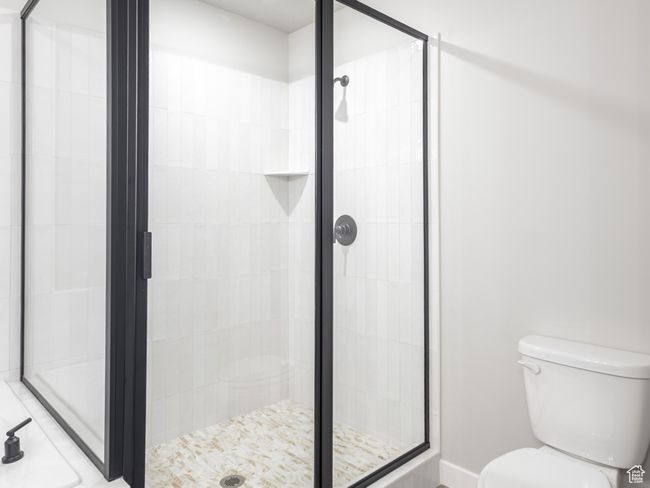 Full bath featuring a shower stall, toilet, and tile patterned flooring | Image 14