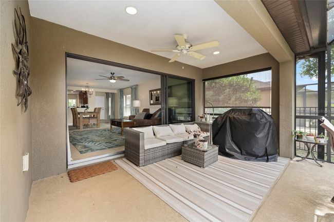 This private backyard lanai is screened to keep bugs out and features a roofed section for all-weather enjoyment. | Image 18