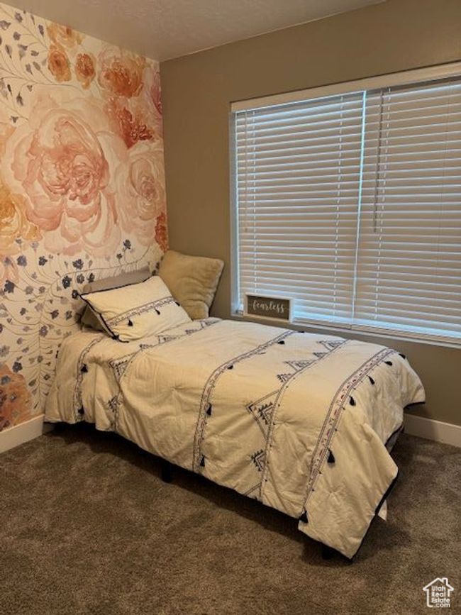 Bedroom featuring baseboards and dark carpet | Image 14