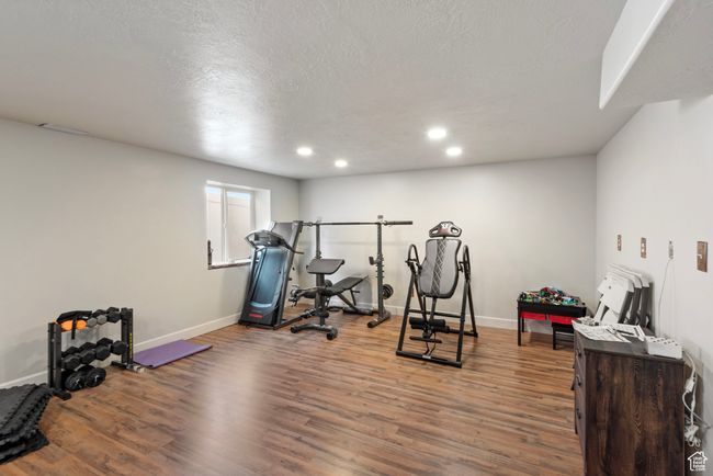 Exercise area featuring recessed lighting, a textured ceiling, baseboards, and wood finished floors | Image 20
