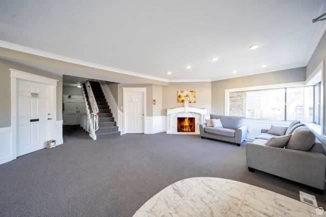 Living room featuring dark colored carpet and crown molding | Image 13