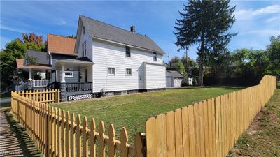 Back of house featuring a yard and a porch | Image 2