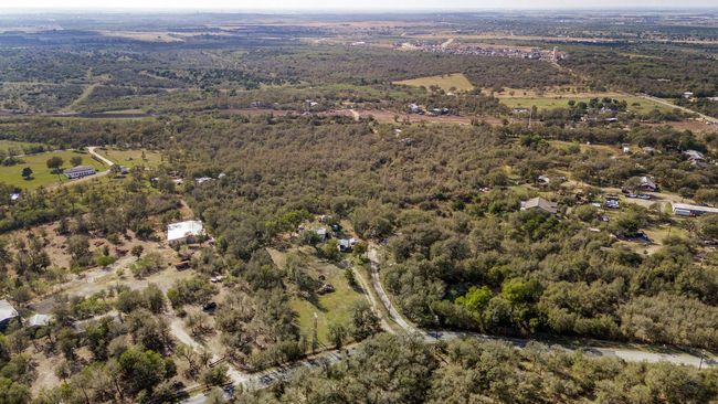 Aerial view of property's location featuring a heavily wooded area | Image 17