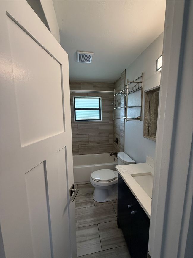 Full bathroom featuring vanity and shower / bathtub combination | Image 7