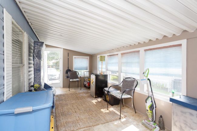 Sunroom / solarium featuring lofted ceiling | Image 6