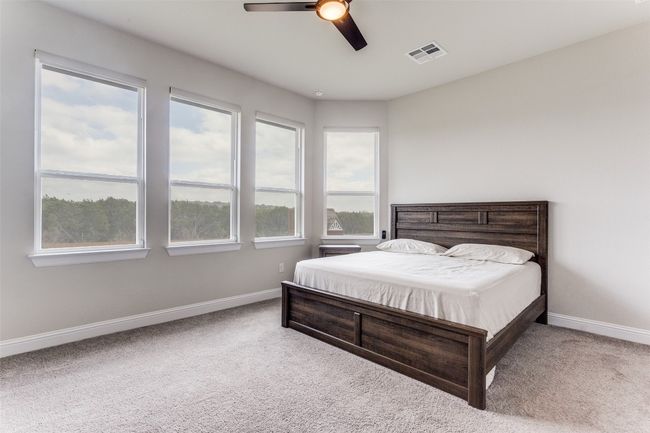 Bedroom with carpet floors and ceiling fan | Image 9