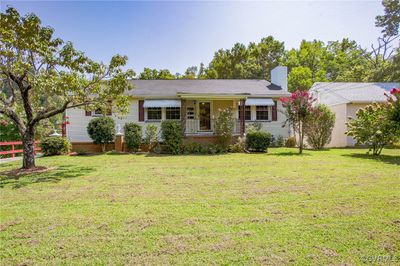 Ranch-style house with a front lawn | Image 1