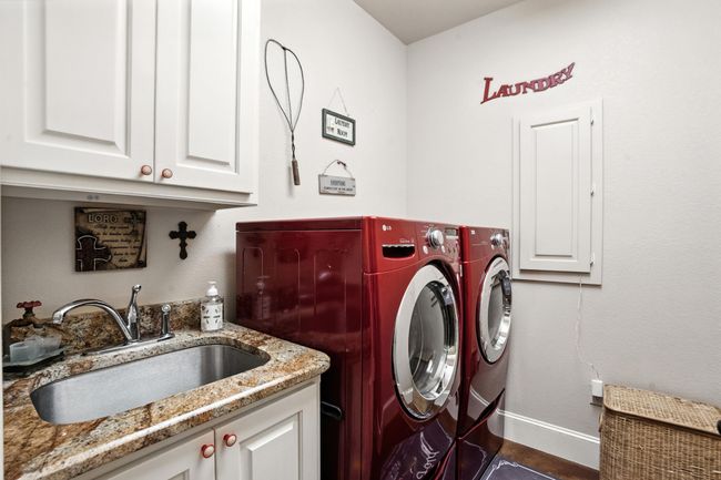 Laundry room with cabinet space and washing machine and clothes dryer | Image 29