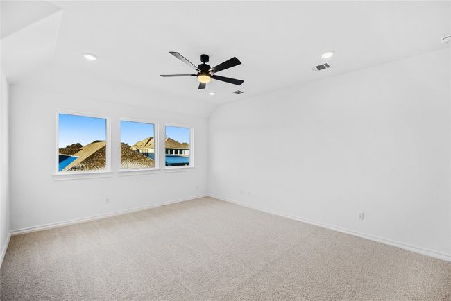Empty room featuring a ceiling fan, light colored carpet, and recessed lighting | Image 16