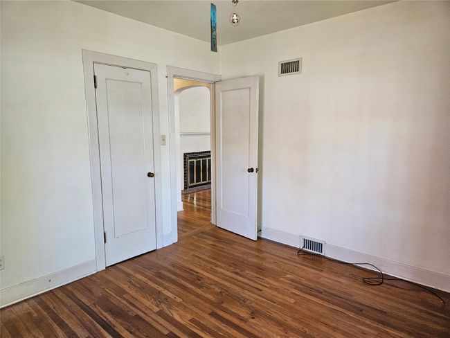 Unfurnished bedroom featuring visible vents, wood finished floors, and baseboards | Image 13