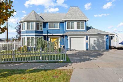 View of front facade with a front yard and a garage | Image 1