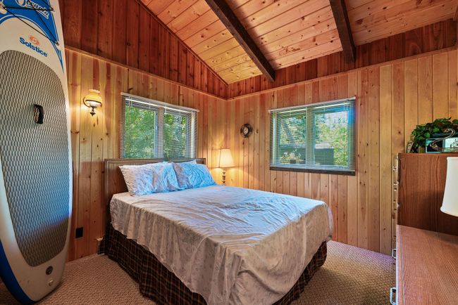 Bedroom featuring wooden walls and carpet | Image 11