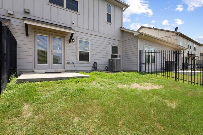 Rear view of house featuring board and batten siding and a patio area | Image 33