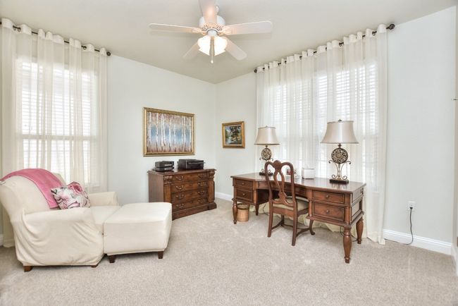 Office featuring light carpet, plenty of natural light, baseboards, and ceiling fan | Image 14