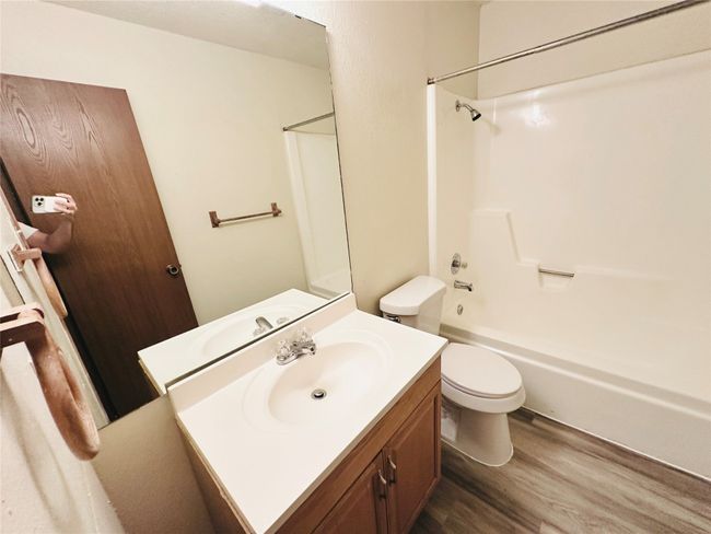 Bathroom featuring wood finished floors, vanity, and shower combination | Image 29