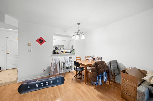 Dining area featuring wood finished floors, baseboards, and a notable chandelier | Image 14
