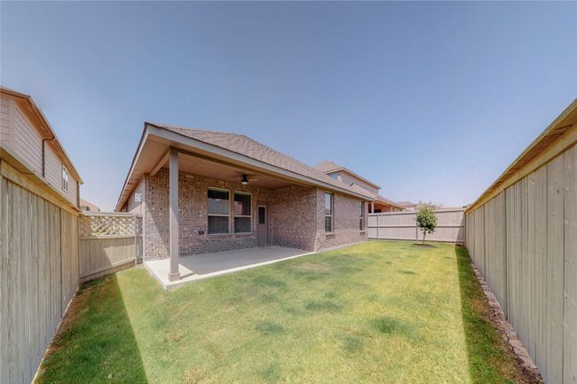 Rear view of house featuring brick siding, a patio area, and a ceiling fan | Image 29
