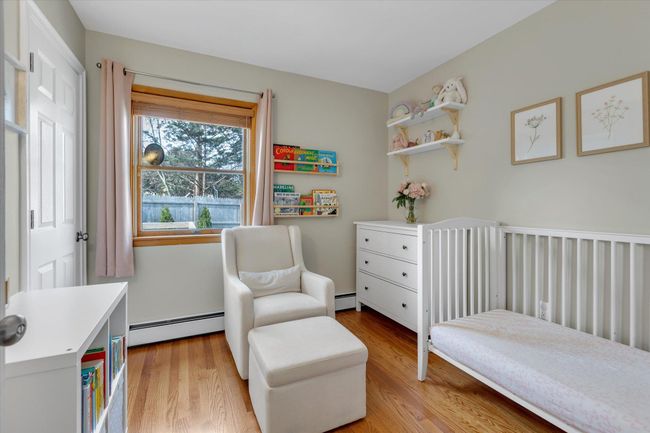 Bedroom 2 featuring hardwood floors and ample sunlight | Image 8