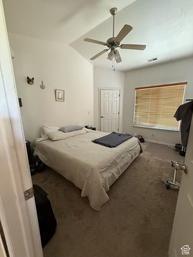Carpeted bedroom with vaulted ceiling and a ceiling fan | Image 11