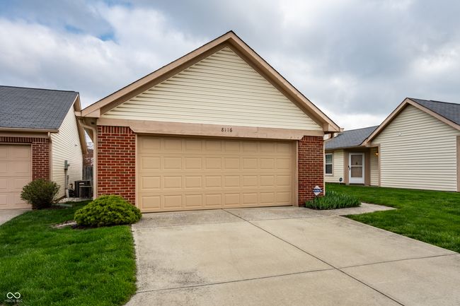 single story detached home with driveway, a front lawn, brick siding, and cooling unit | Image 25