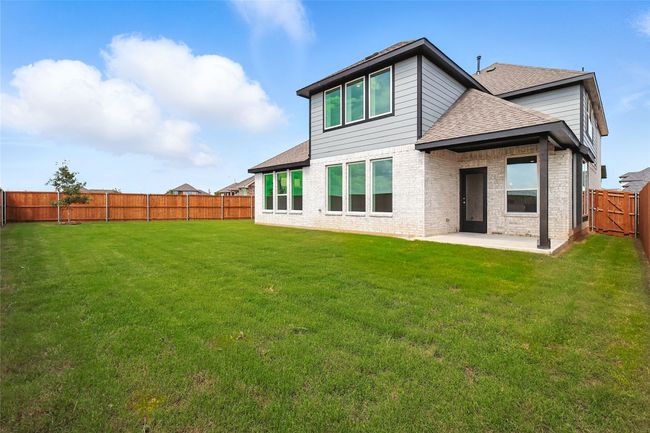 Back of house with roof with shingles, a patio area, a fenced backyard, and brick siding | Image 28