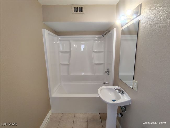 Full bathroom with shower / tub combination, visible vents, tile patterned flooring, and baseboards | Image 8