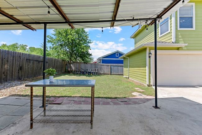 Fenced backyard with an attached garage and a patio | Image 38