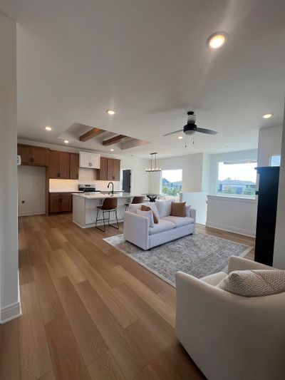 Living room featuring ceiling fan, sink, and light hardwood / wood-style flooring | Image 2