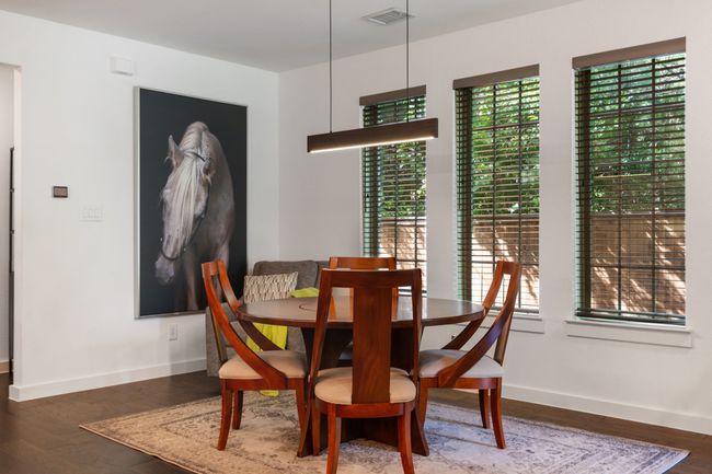 Dining space featuring wood finished floors and baseboards | Image 10