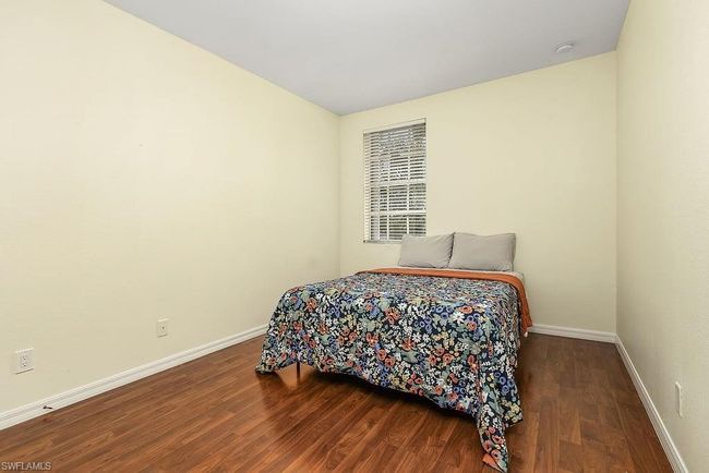 Bedroom with baseboards and wood finished floors | Image 18