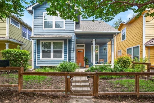 View of front of property featuring a porch, a fenced front yard, and roof with shingles | Image 31