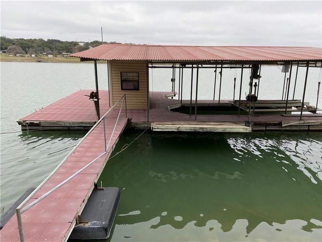 Dock area with a water view and boat lift | Image 18