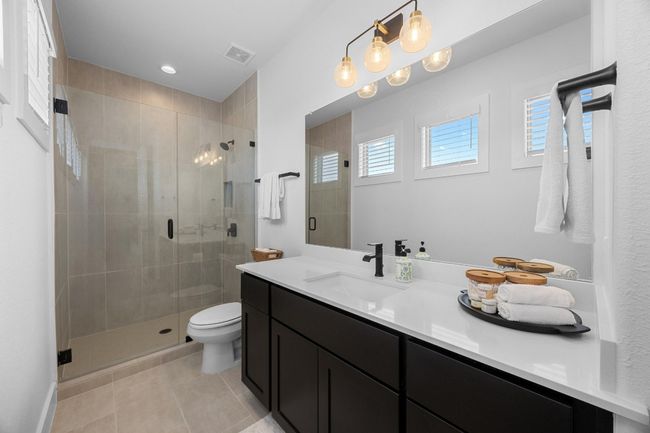 Full bath with healthy amount of natural light, vanity, a shower stall, tile patterned floors, and recessed lighting | Image 23