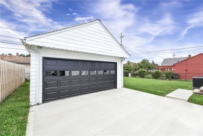 Garage featuring central AC and a yard | Image 3